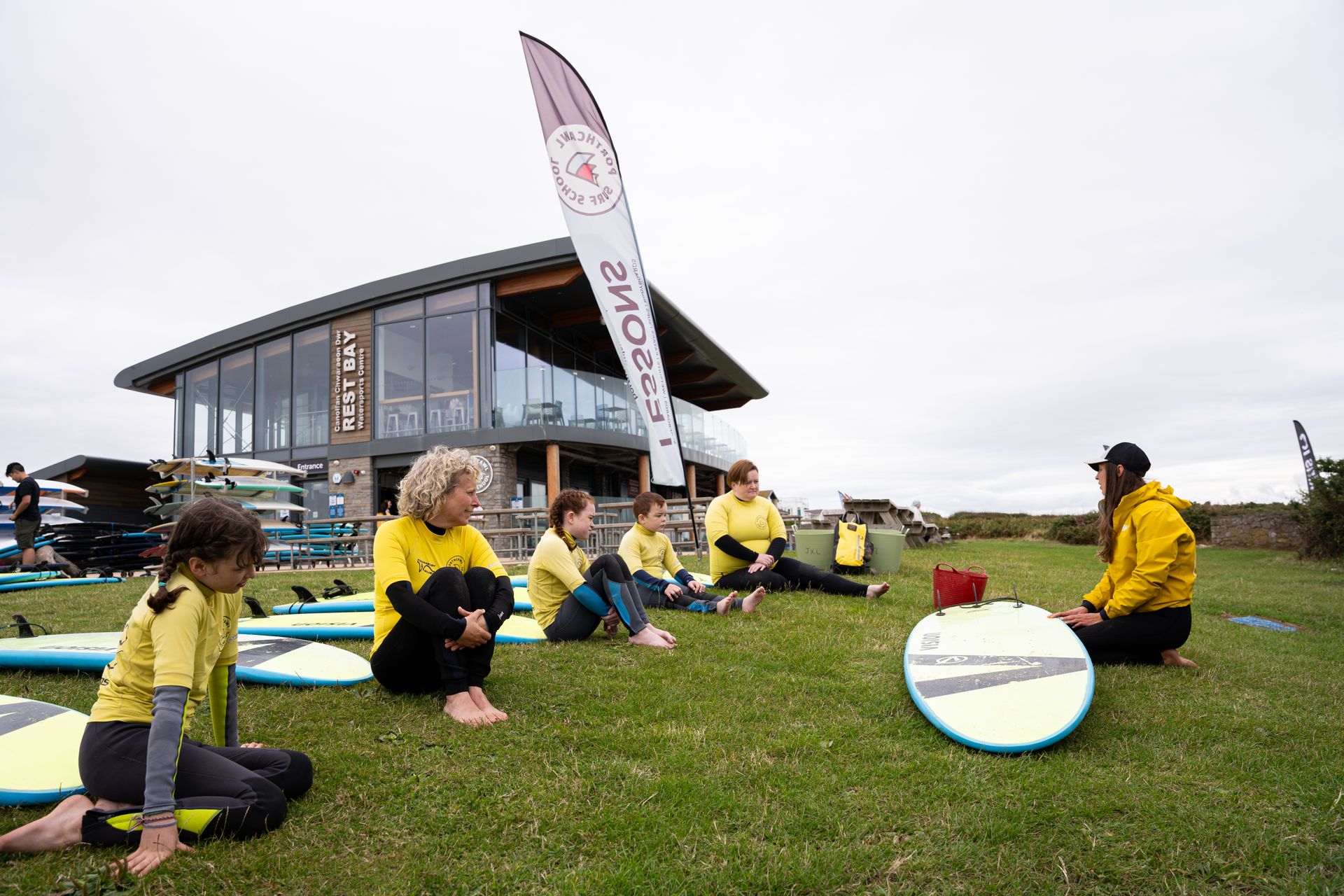An instructor with a group of surfing participants